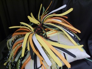 cyberlox crin falls, with orange and yellow braids and twitst, glow in the dark accents, and a foam feather crown.